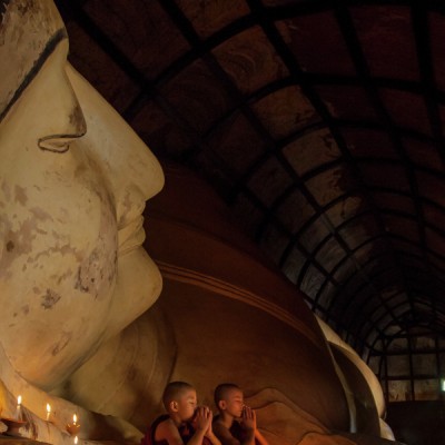 Young monks with sleeping Buddha