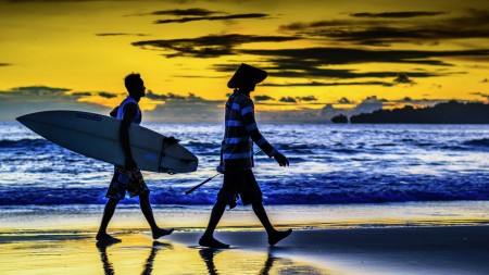 Surfers and fishermen, they both enjoy an incredible sunset in l