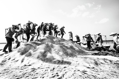 Salt and worker under blazing sunlight