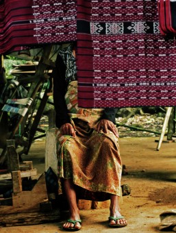 weaver behind her works
