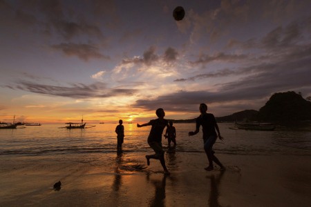 Beach soccer at sunset