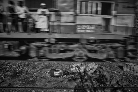 Old woman sleeping beside the rail line