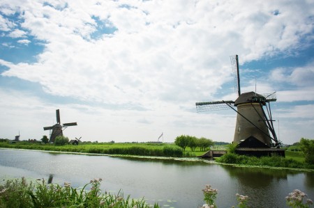 Windmills on riverbank